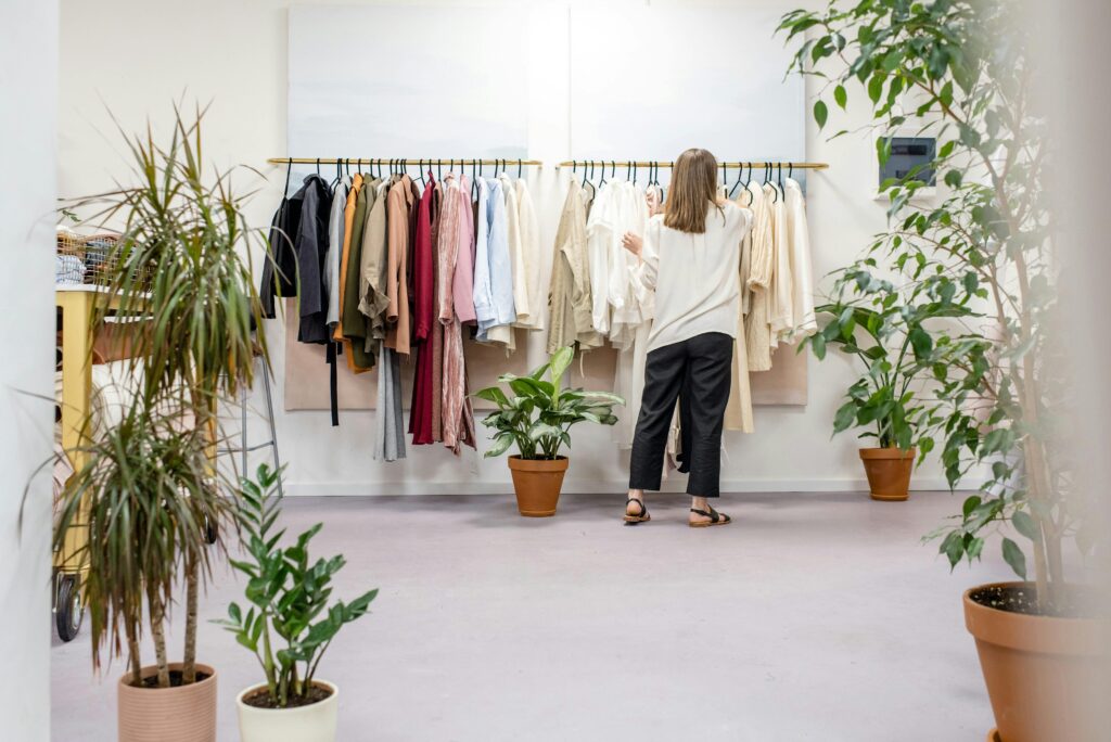 image of a woman picking out clothes from a rail